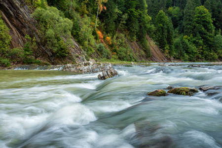 Long exposure rapids of a mountain river with shallow depth of field