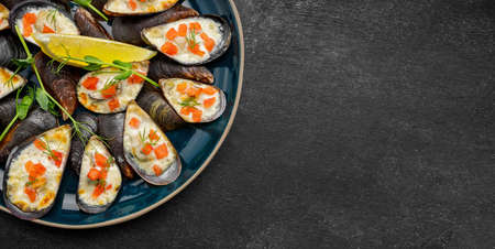 Mussels on a plate with baked cheese and red fish cubes