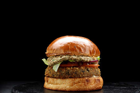 Burger with meat cutlet, vegetables and herbsの写真素材