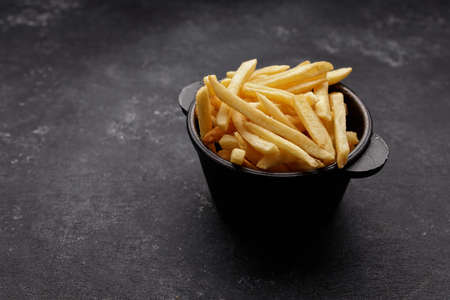 French fries on a dark background, with space for textの写真素材