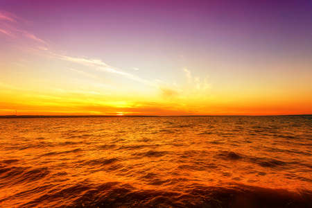 Beautiful sunset with clouds and water in the foreground