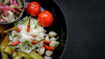 Assorted pickled vegetables on a plate. cabbage, cucumbers, tomatoes garlicの写真素材