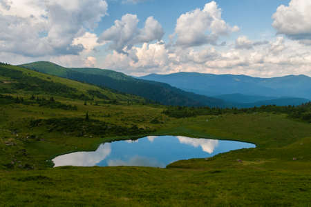 Mountain lake in the Carpathians, against the background of the sky. summer landscape