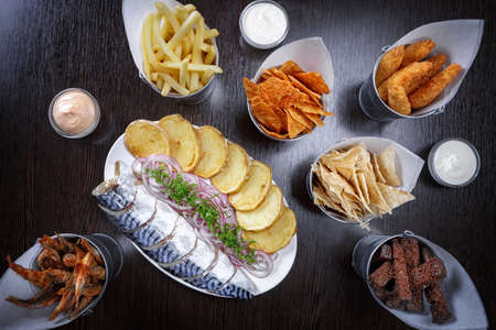 Snack for beer, fried fish, chips, nuggets croutons herring