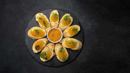 Bruschetta with pike caviar. on a dark background with space for text
