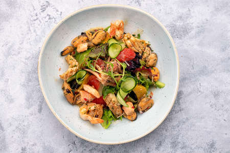 Salad with seafood, vegetables and herbsの写真素材