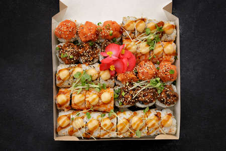 Sushi set in a delivery box on a dark