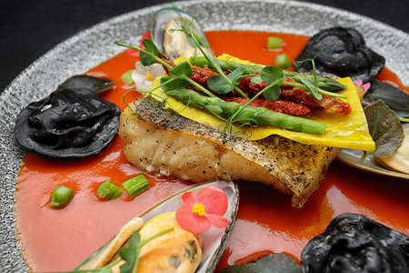 Fried pike-perch fillet with mussels and ravioli