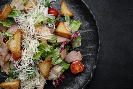 Caesar salad on a black plate. Horizontalの写真素材