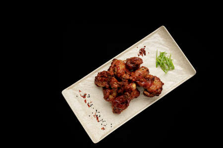 Grilled chicken legs in sauceの写真素材