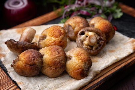 Mushrooms Champignons grilled on a wooden board. 45 degreesの写真素材
