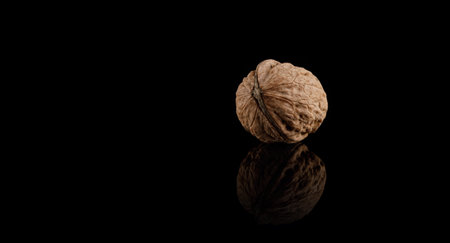 Walnut on black mirror background with reflectionの写真素材