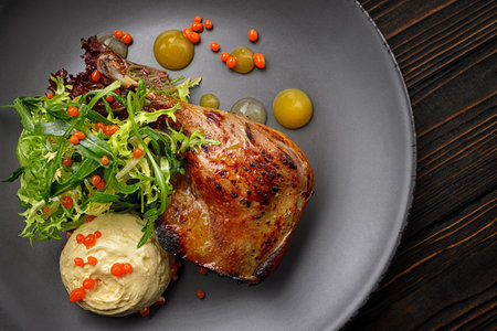 Baked duck leg with herbs, pumpkin and sauceの写真素材