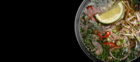 Fo-bo soup made of beef with spices and rice noodles, on a black background