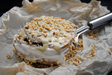 Cinnabon bun with cinnamon, pistachio cream, and pistachios, on baking paper