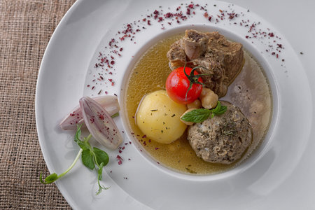 Soup shurpa with lamb on a plate