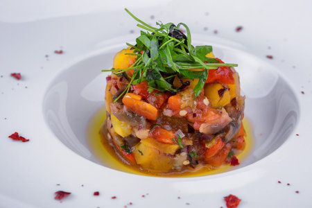 baked vegetable salad on a white plate, close-upの写真素材