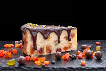 cottage cheese dessert with chocolate and candied fruits, on a black backgroundの写真素材