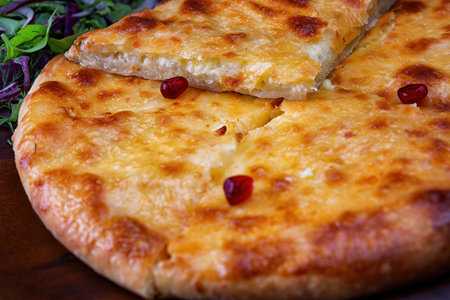 A Traditional Georgian Dish of Megrelian Khachapuri with Fresh Herbs and Greensの写真素材