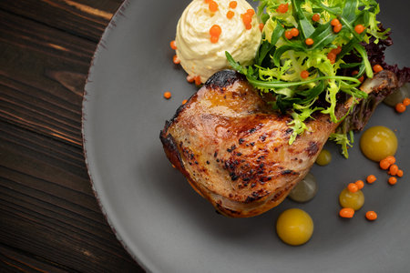 Flavorful duck leg dish with crispy skin and vibrant produceの写真素材