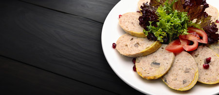 delicious stuffed chicken dish with fresh lettuce and juicy tomatoes. On a black wooden backgroundの写真素材