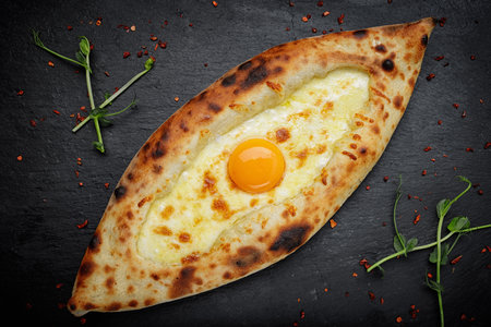 baked khachapuri with egg and cheese, up closeの写真素材