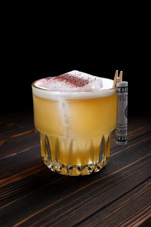 Whiskey cocktail in a whiskey glass, with ice and decorations, on a dark wooden backgroundの写真素材