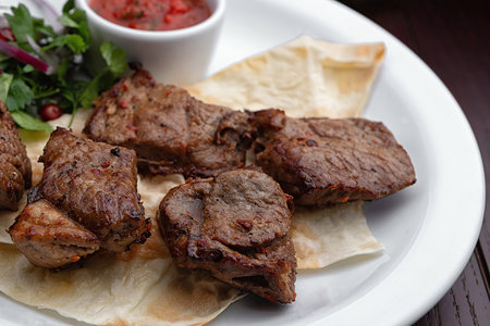 Shish kebabs on a white plateの写真素材
