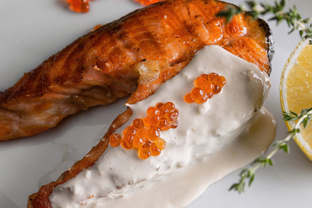 Salmon fillet with red caviar and lemonの写真素材