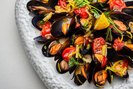 Boiled mussels with spices on a white plate on a white backgroundの写真素材