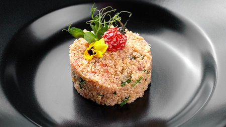 Cous-cous on a black plateの写真素材