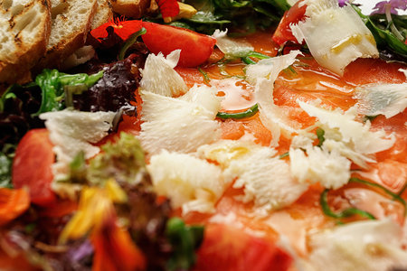 Salmon carpaccio with cheese, tomatoes, and crouton, close-upの写真素材