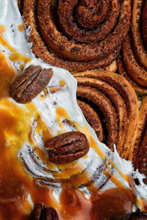 Cinnabon rolls with cinnamon, nougat, cream and nuts, close-upの写真素材
