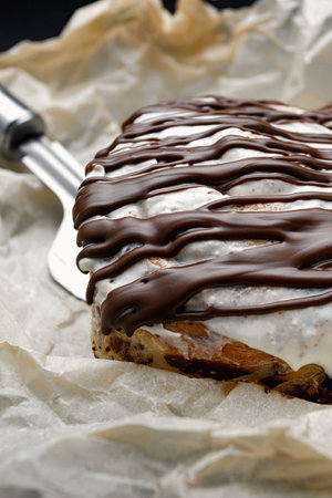 Cinnabon bun with cinnamon, butter and cream, on baking paperの写真素材
