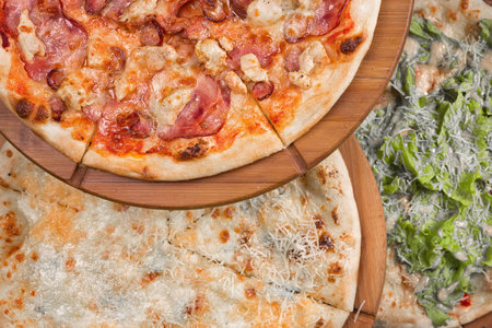Assorted pizza on a wooden board