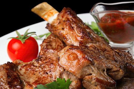 Grilled meat on the bone with barbecue sauce and parsley, Close upの写真素材