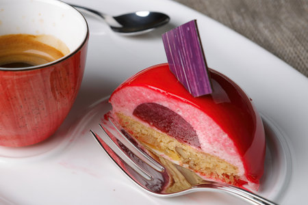 Cake with a cup of coffee on a white plateの写真素材