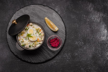 Okroshka on kefir with quail eggs, dark backgroundの写真素材