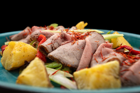 Sliced smoked meat with vegetables and potatoes