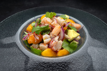 Fresh shrimp ceviche served in a bowl on a dark textured surface. Bright colors and citrus garnish.の写真素材
