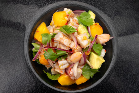 Fresh shrimp ceviche served in a bowl on a dark textured surface. Bright colors and citrus garnish.の写真素材