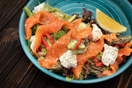 Fresh and vibrant salad made with tender salmon, a mix of leafy greens, and soft cream cheeseの写真素材