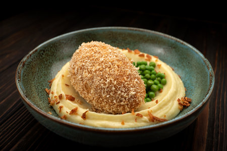 Traditional Kyiv cutlet with mashed potatoes and green peasの写真素材