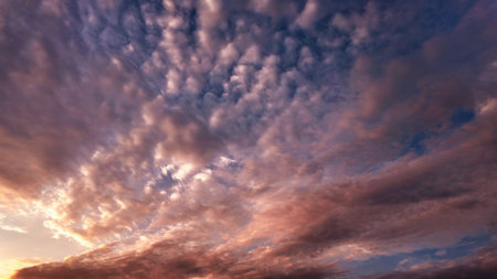 Soft and colorful dawn sky with tinted fluffy clouds. Perfect for wallpapers and backgrounds. Highlights themes of atmosphere, ecology, environmentの写真素材