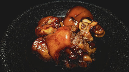 Fried pork feet on vintage pan, traditional rustic meal for food photography and cuisine projects