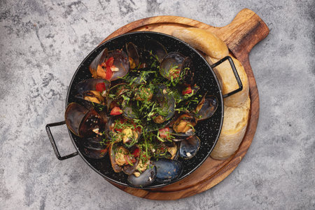 Mussels with spices on wooden board, gourmet seafood meal for culinary and restaurant photography