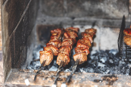 Juicy grilled shashlik skewers cooking inside a hot charcoal grill, flavorful, and authentic.の写真素材