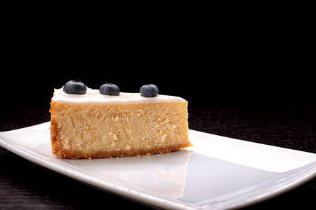 Delicious cheesecake on black background.