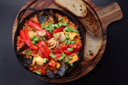Creamy seafood risotto served with fresh bread.の写真素材