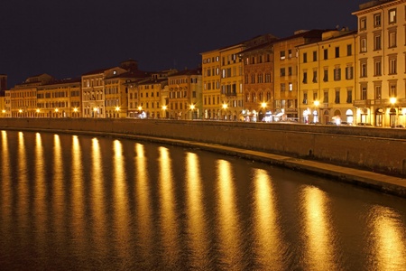 Pisa Riverside Night View with bright reflections over river Arno の写真素材